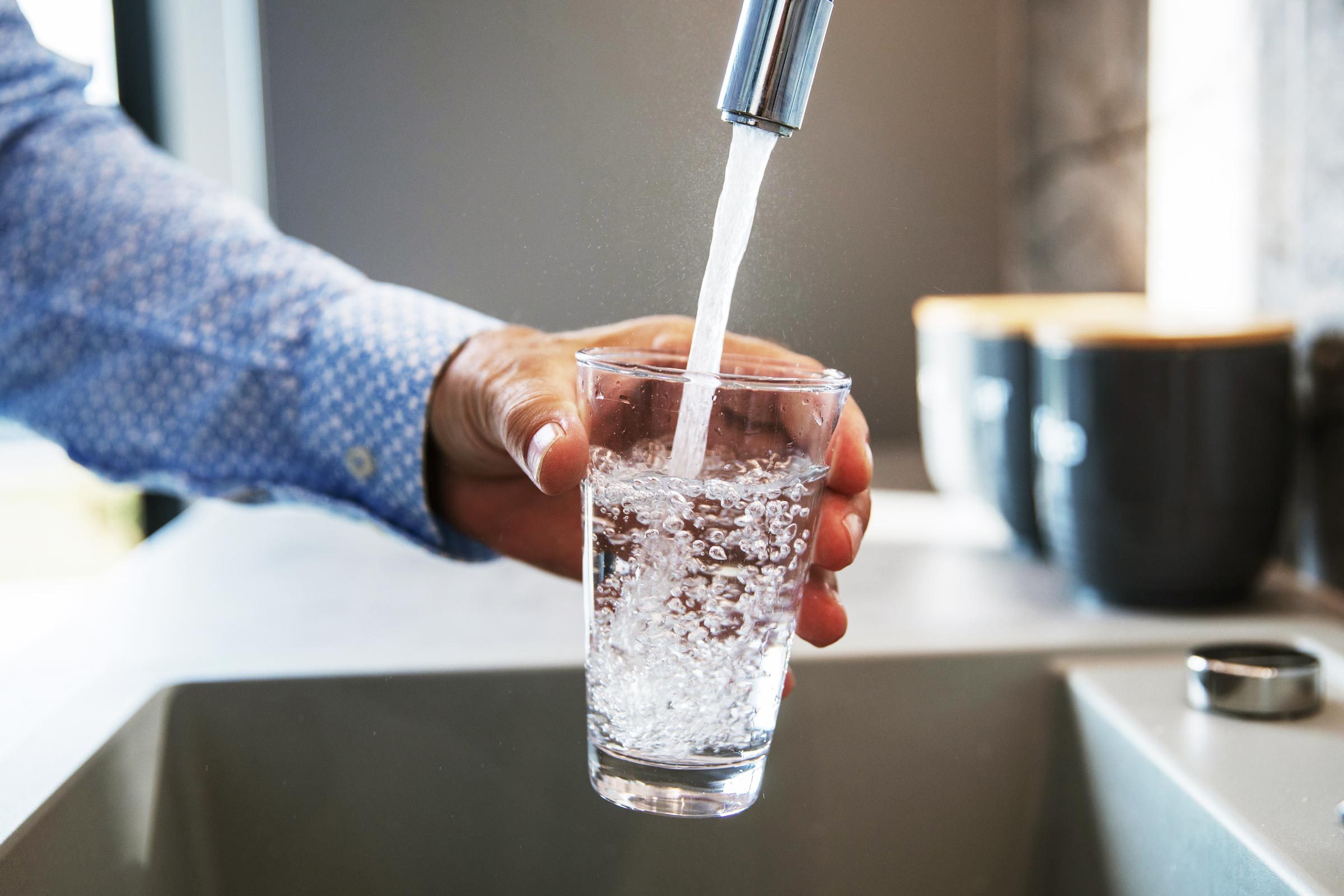 An image of a glass being filled with tap water.